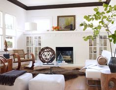 a living room filled with furniture and a fire place in the middle of a room