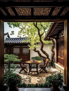 an outdoor table and chairs are in the middle of a courtyard with potted trees