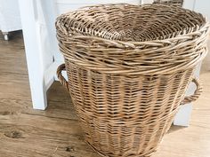 a large wicker basket sitting on the floor