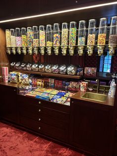 an assortment of candy and candies on display in a store with red carpeting