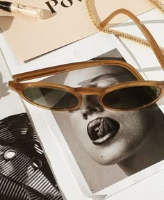 a pair of sunglasses sitting on top of a book