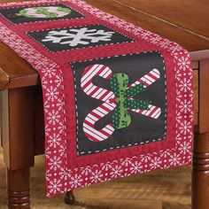 a christmas table runner on top of a wooden table