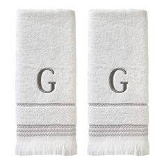 two white towels with the letter g on them