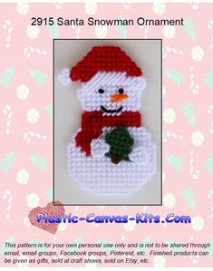 a cross stitch snowman ornament with a red hat and scarf