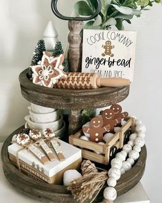 a cake stand with gingerbreads, cookies and other holiday treats on it's tray