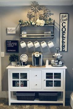 the coffee bar is decorated with white flowers and greenery on it's shelf