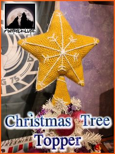 a christmas tree topper with a yellow star hanging from it's center and the words, christmas tree topper