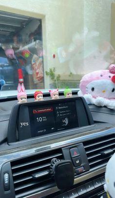 hello kitty headphones sitting on the dashboard of a car