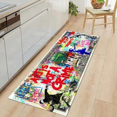 a kitchen area rug with graffiti on the floor