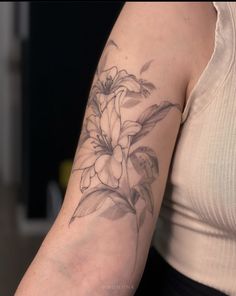 a woman's arm with a flower tattoo on the left side of her arm