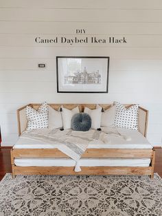 a bed sitting on top of a wooden floor next to a white and black rug