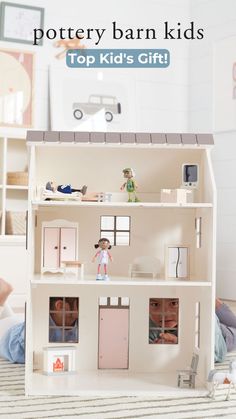 a doll house with the words pottery barn kids top kid's gift