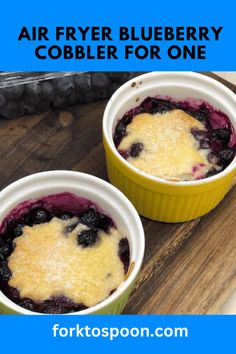 two bowls of blueberry cobbler on a cutting board with text overlay reading air fryer blueberry cobbler for one