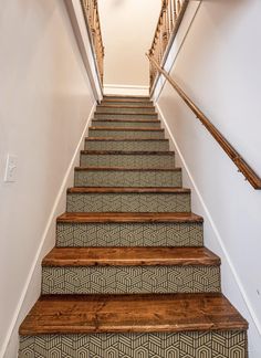 the stairs are lined with carpet and wood