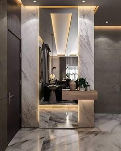 a bathroom with marble walls and flooring next to a sink in the middle of it