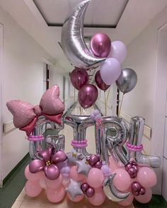 balloons and heliums are arranged in the shape of letters