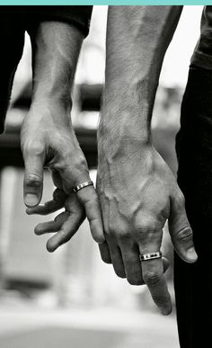 black and white photograph of two people holding hands