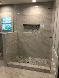 a walk in shower sitting inside of a bathroom