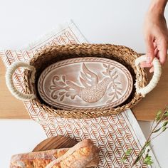 someone is holding a tray with bread in it