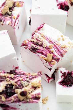 several pieces of cake sitting on top of a white plate with blueberries and crumbs