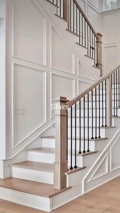 a staircase with white walls and wooden floors