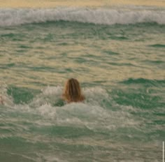 two people swimming in the ocean on surfboards