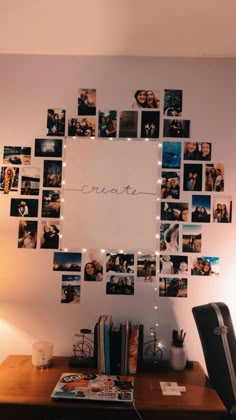 a desk with pictures on the wall and lights strung from it's sides to spell out create