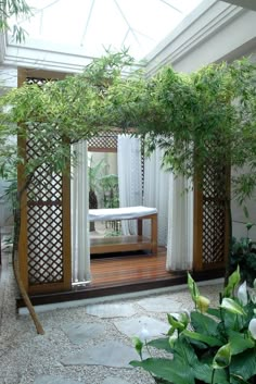 the inside of a house with an open door and white curtains on it's windowsill