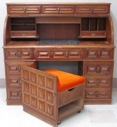 a wooden desk with an orange cushion on it