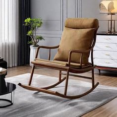 a brown rocking chair sitting on top of a wooden floor