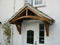 a white door with a wooden roof and window