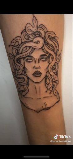 a woman's arm with a tattoo on it that has an image of a snake crawling out of her head