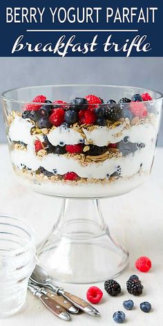 berry yogurt parfait breakfast trifle in a glass dish with berries on the side