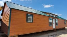 a small wooden house sitting on top of a trailer