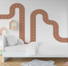 a child's bedroom with a white bed and brown road wall decals