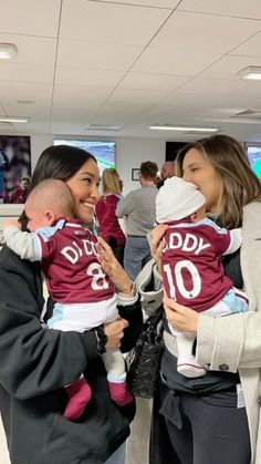 two women and a baby are smiling at each other