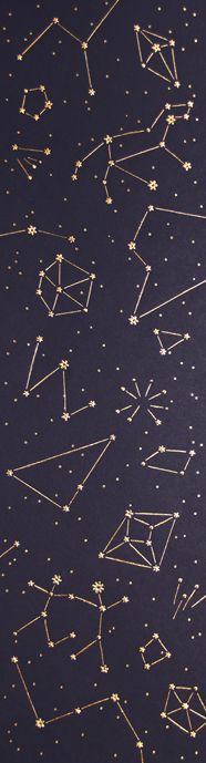 gold stars and lines on black paper with white dots in the middle, as seen from above