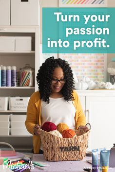 a woman sitting at a table with a basket full of yarn