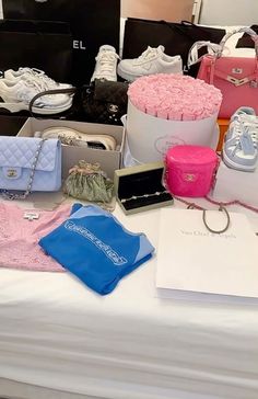 a table topped with lots of different types of purses and handbags next to each other