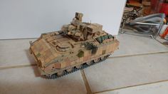 a toy tank sitting on top of a tile floor