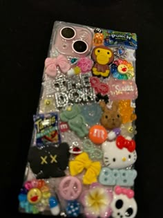 a cell phone covered in lots of different types of buttons and magnets on it