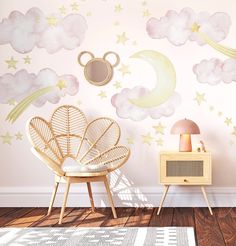 a room with a rattan chair and wallpaper that has clouds, stars and moon on it