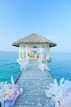 a pier with flowers and people on it