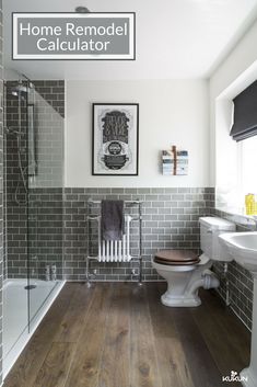 a white toilet sitting next to a bath tub in a bathroom on top of a hard wood floor