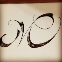 the letter o is drawn in black ink on a white paper with a wooden frame