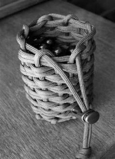 a woven basket sitting on top of a wooden table