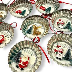 six christmas ornaments with santa clause on them