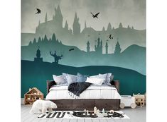 a room with a bed, rug and wallpaper that has castle silhouettes on it