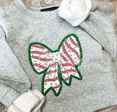 a gray sweatshirt with a bow on it