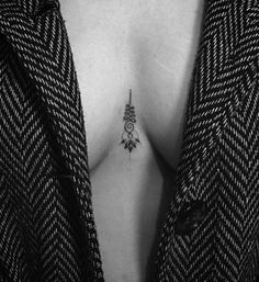 a woman with a small tattoo on her chest